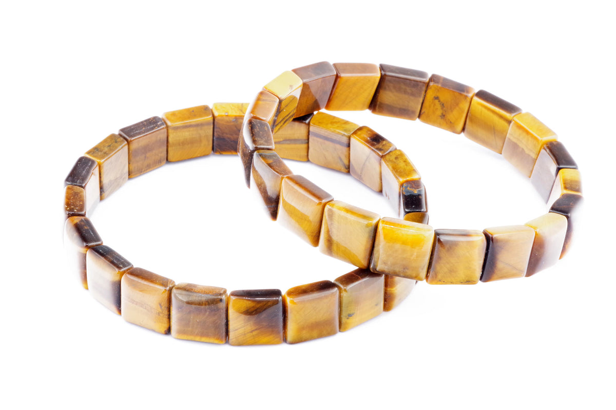 Two polished tiger’s eye crystal bracelets featuring square beads with golden brown and honey tones, styled as the Tiger eye bracelet – Square for crystal jewellery lovers.
