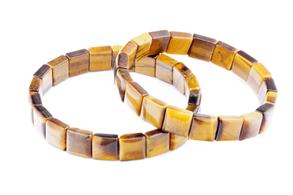 Two polished crystal bracelets made of square tiger eye beads with warm golden and brown tones, showcasing the natural chatoyancy of gemstones, named Tiger eye bracelet – Square.