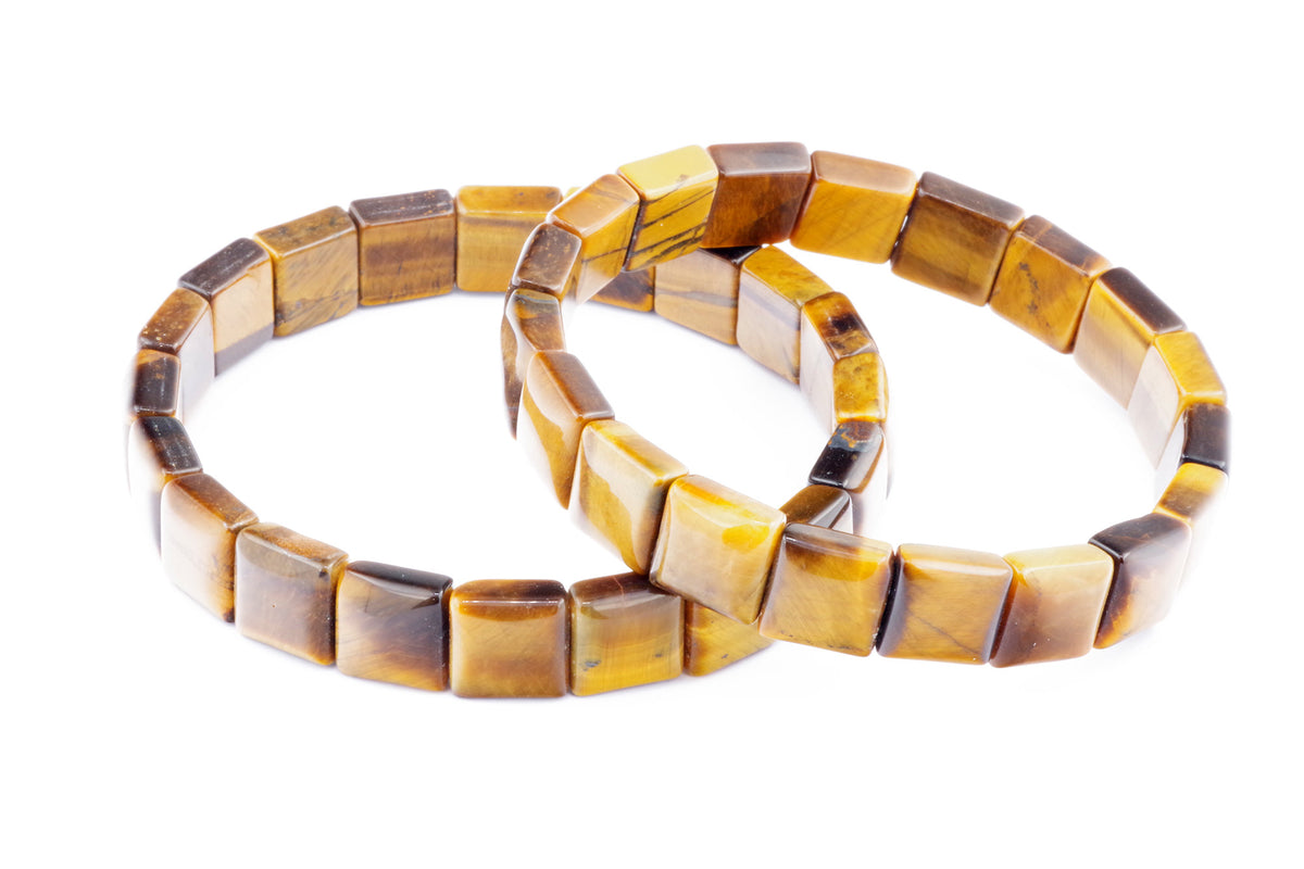 Two square-shaped natural tiger's eye crystal bracelets with polished golden brown and dark brown hues, showcasing the Tiger eye bracelet – Square design.