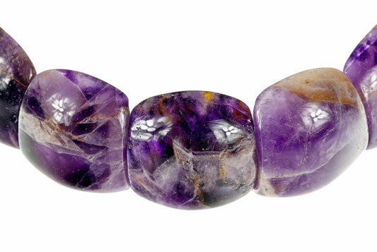 A close-up of a bracelet with polished, irregular beads showing purple amethyst and brownish inclusions on a white background.