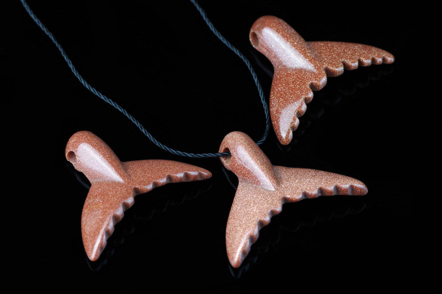 Goldstone pendant – Dolphin tail