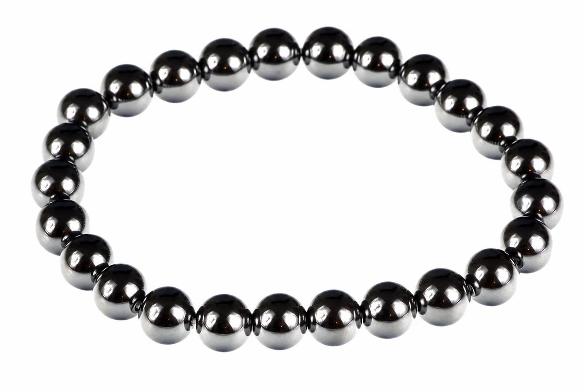 A bracelet made of round, dark metallic beads with a silver-toned finish arranged in a circle on a white background.