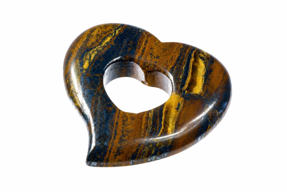 A polished heart pendant with an open heart-shaped center has brown, gold-colored and dark bands against a white background.