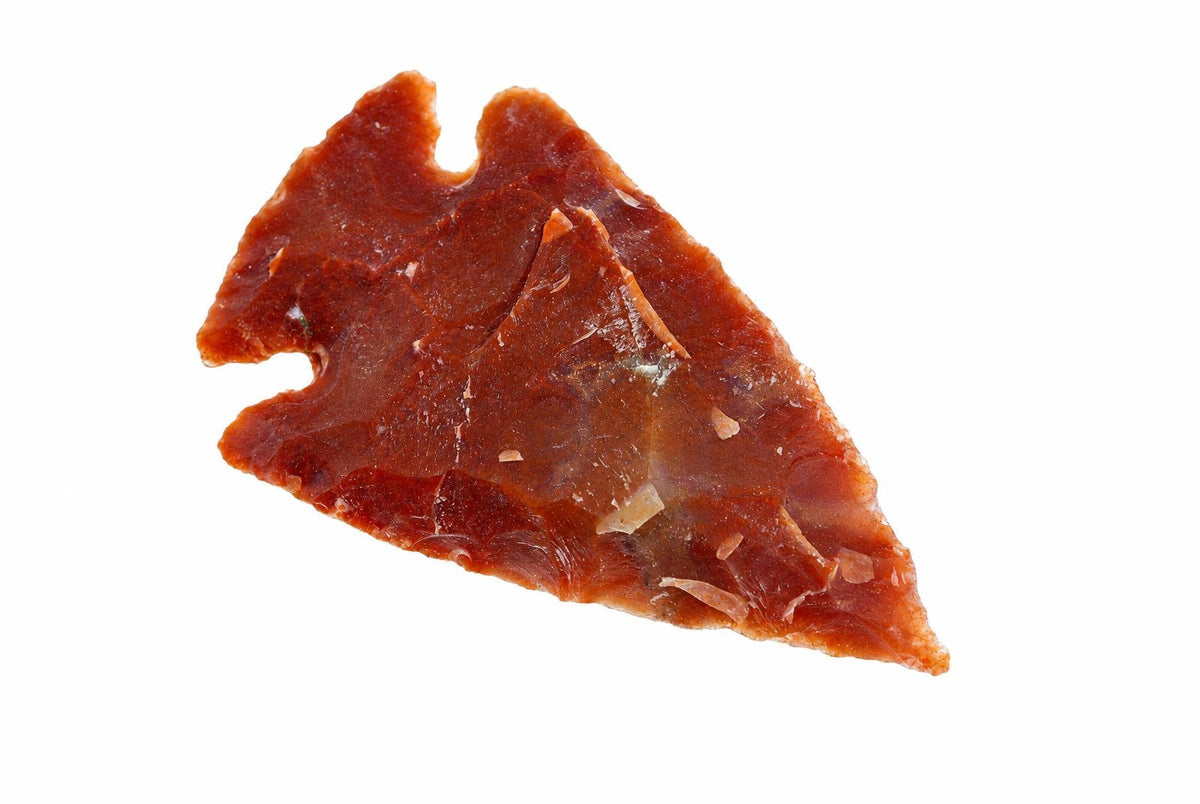 A triangular jasper pendant with a notched top, reddish-brown and translucent, on a white background.
