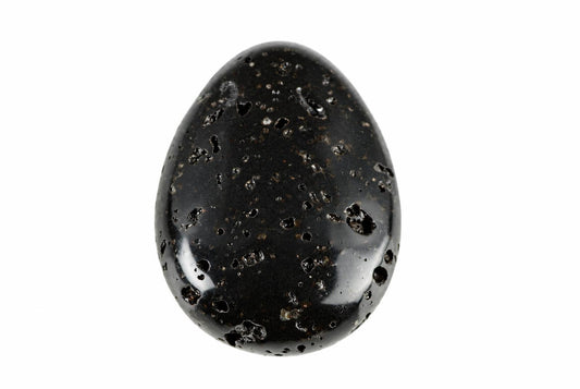 A polished black lava stone pendant with a smooth, egg-like shape and numerous small holes on its surface against a white background.