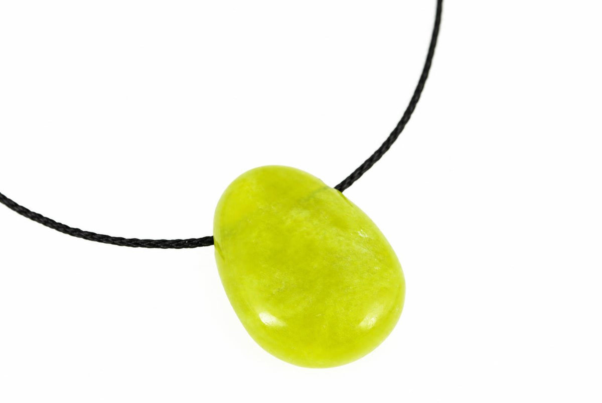 A smooth, oval-shaped pendant in lime green with a glossy finish hangs from a black cord against a white background.