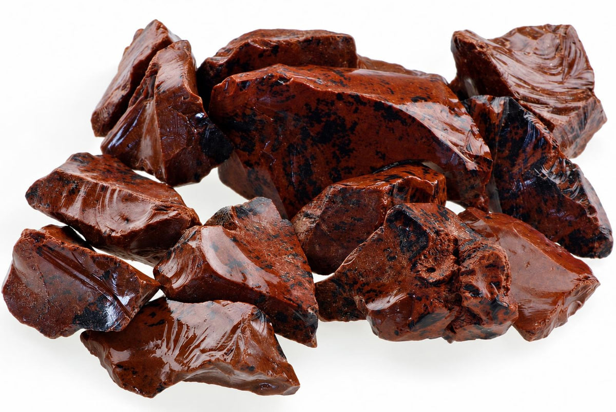 A pile of raw mahogany obsidian pieces with glossy dark brown surfaces and black speckles on a white background.