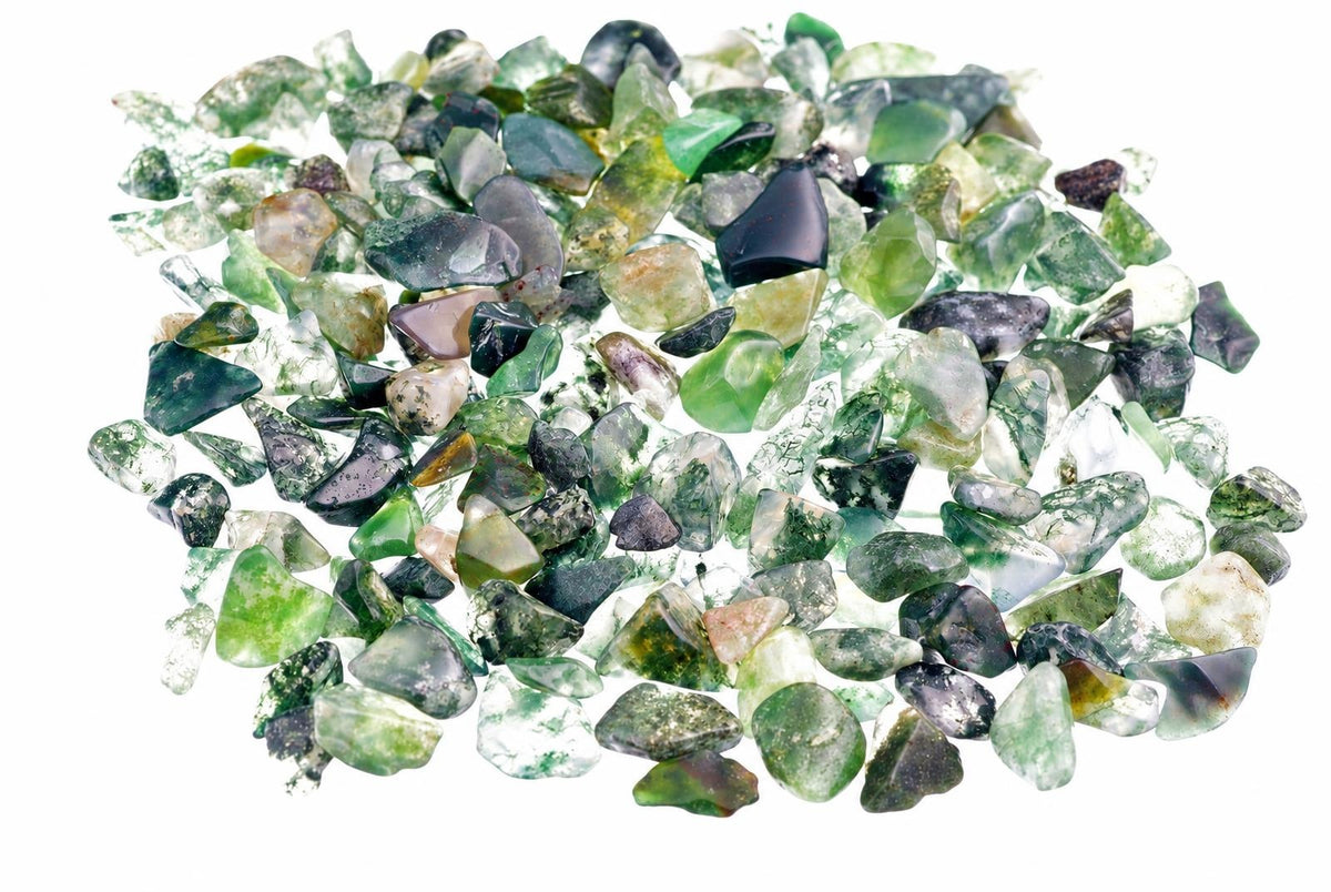 A pile of small, rough moss agate stones in various shades of green and grey on a white background.