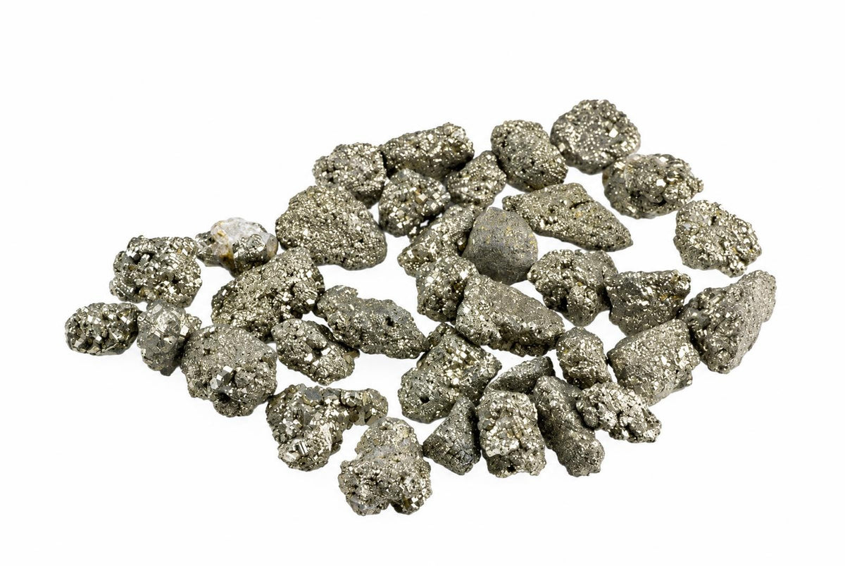 A cluster of small rough pyrite pieces with uneven sparkling metallic surfaces is spread across a plain white background.