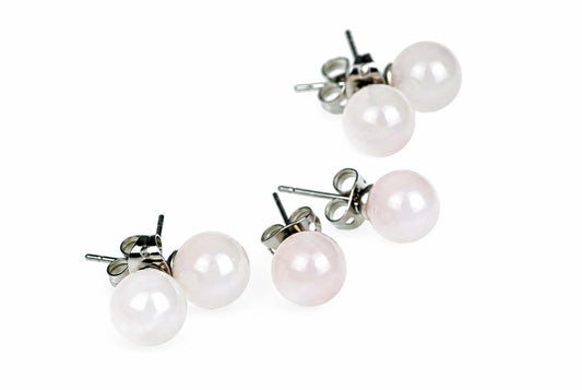 Four round, pale pink and white gemstone stud earrings with silver-toned posts on a white background.
