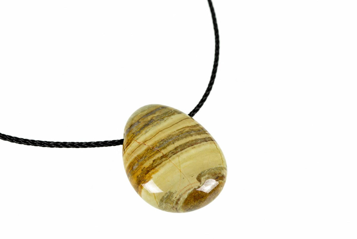 A polished, teardrop-shaped pendant with horizontal stripes of cream, brown and tan on a black cord against a white background.