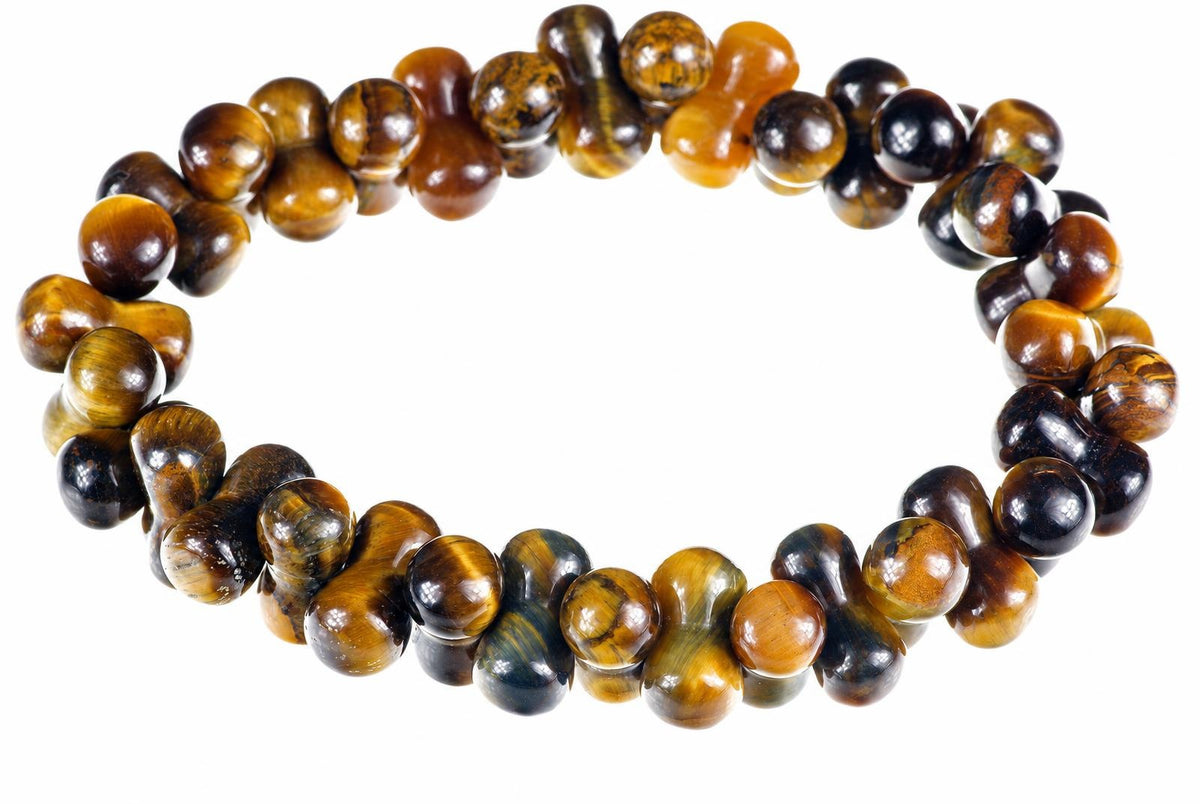A bracelet of glossy curved beads with golden-brown and dark bands forms a ring on a white background.