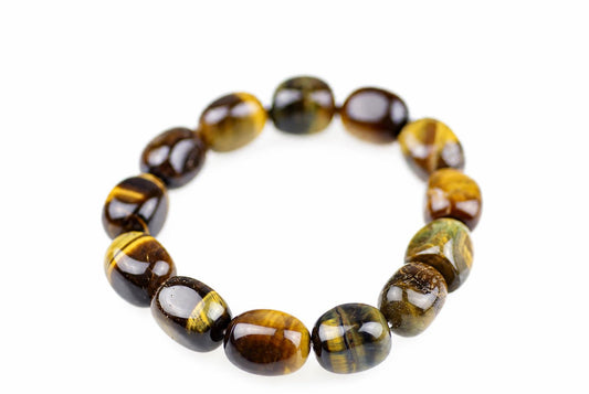 A bracelet made of polished oval beads with dark brown and golden-yellow tiger eye patterns on a white background.