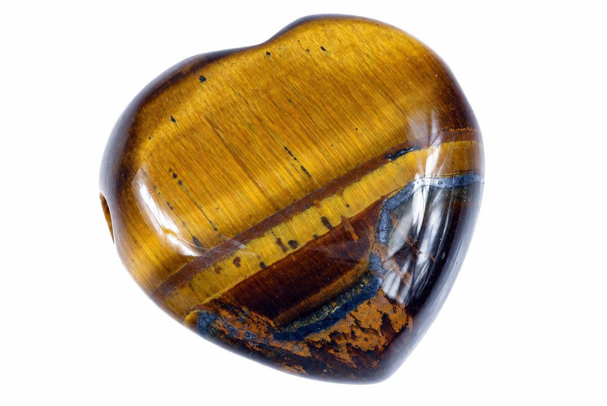 A polished heart-shaped bead with golden brown and dark stripes, set against a white background.