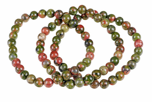 A bracelet of round beads with green, red and black speckled patterns on a white background.