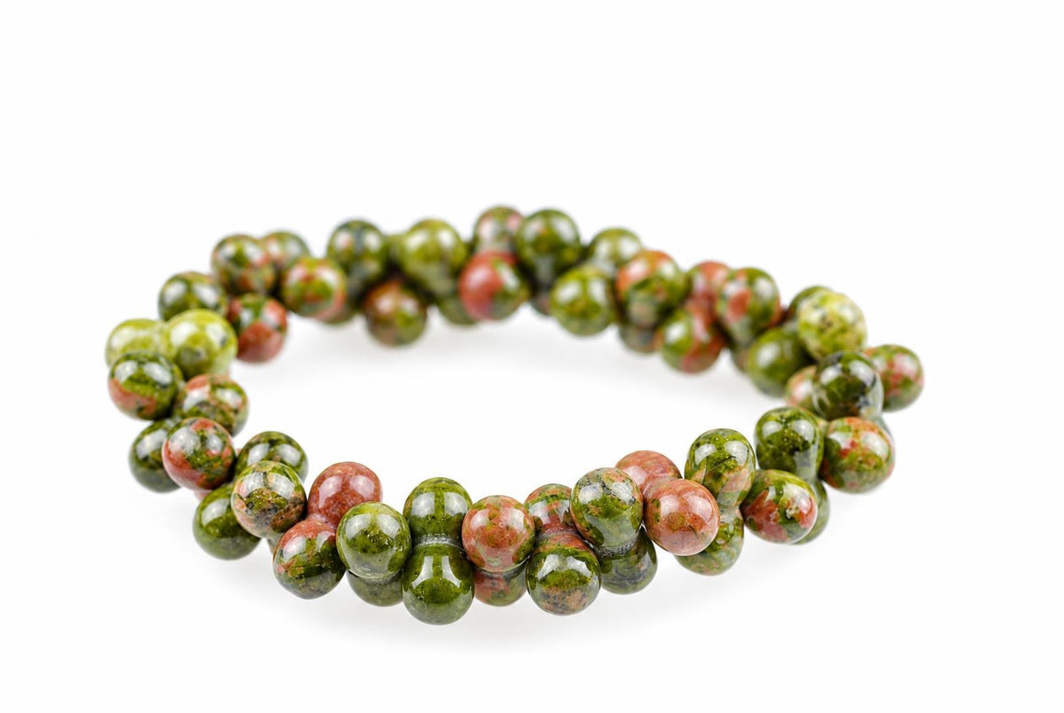 A bracelet of round beads with green and reddish-brown speckled patterns on a white background.