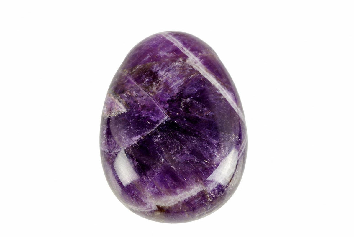 A polished, oval-shaped amethyst stone with deep purple and lighter white streaks on a plain white background.