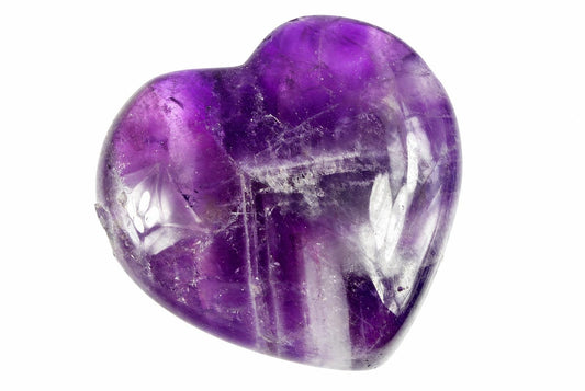 A polished heart-shaped amethyst crystal with deep purple and lighter translucent areas, set against a white background.