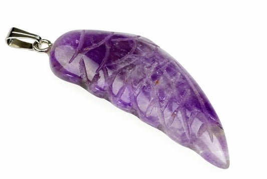 A polished purple amethyst pendant shaped like a wing, with silver-toned metal bail, on a pale surface.