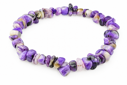 A bracelet made of polished, irregular chips of purple charoite with black and white swirls on a white background.