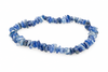 A bracelet made of irregular blue and white chips on a pale surface.