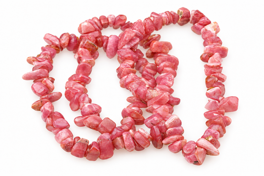 A necklace of irregular pink rhodochrosite chips arranged in a loose coil on a white surface.