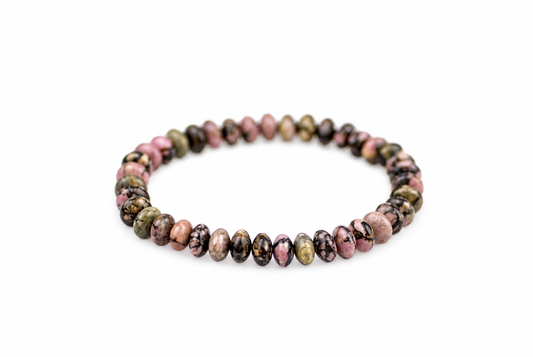 A bracelet of round, polished beads in pink, green, and black patterns on a white background.