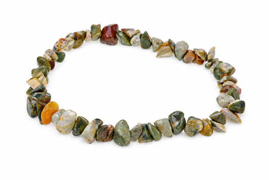 A bracelet made of polished, irregular chips in green, brown, orange and grey tones arranged on a white surface.