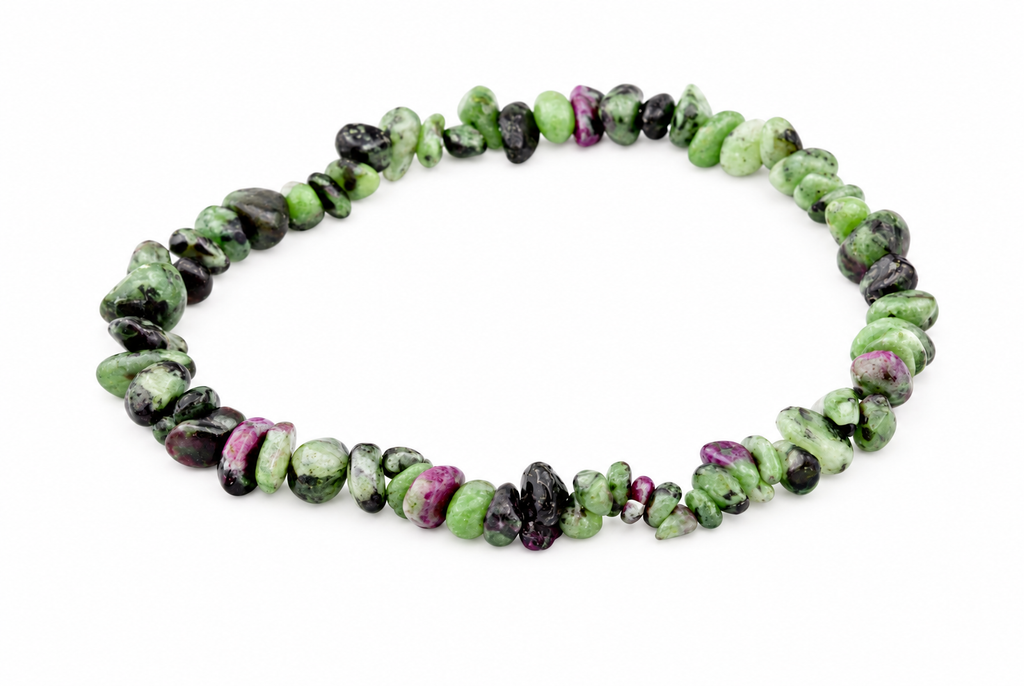 A bracelet of irregular chips in green, black and purple stones arranged on a white surface.