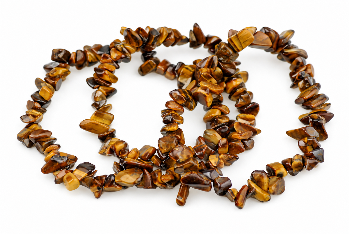 Overlapping bracelets of irregular polished golden-brown stone chips lie on a white background.
