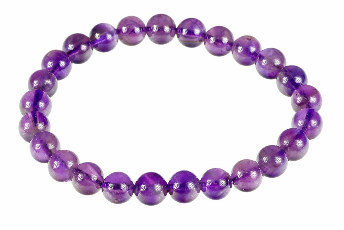 A bracelet made of round, polished purple beads arranged in a circle on a white background.