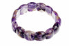 A bracelet made of polished, irregularly shaped beads in shades of purple, white and brown on a white background.