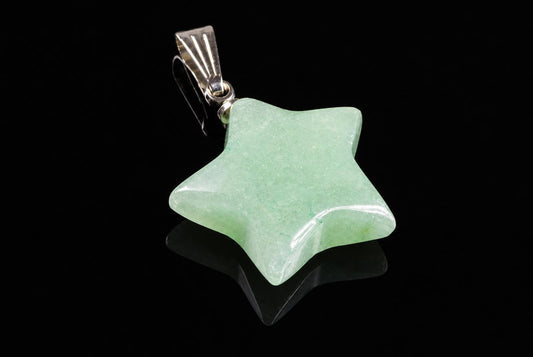A silver-toned pendant with a five-pointed star aventurine stone on a dark reflective surface.