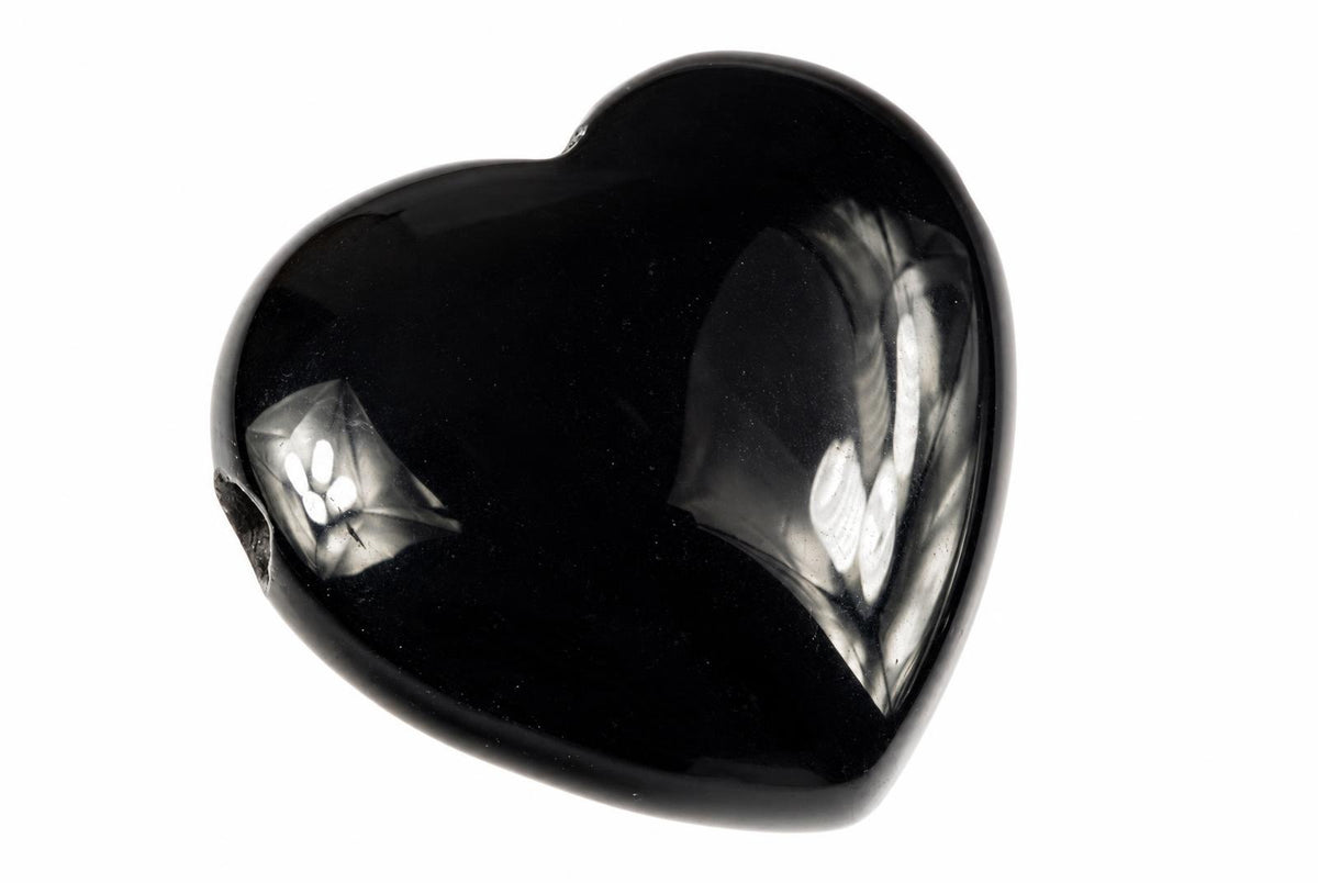 A glossy black heart-shaped pendant with a smooth, reflective surface showing light reflections on a white background.