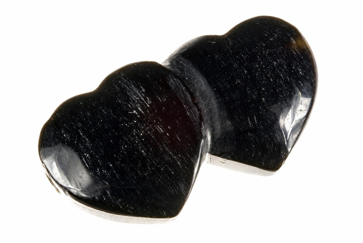 A polished black stone pendant shaped like two connected hearts, set against a white background.