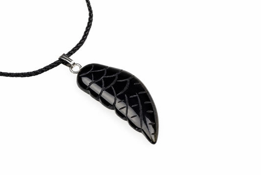 A glossy black onyx wing pendant with carved feather lines hangs from a black cord against a plain white background.