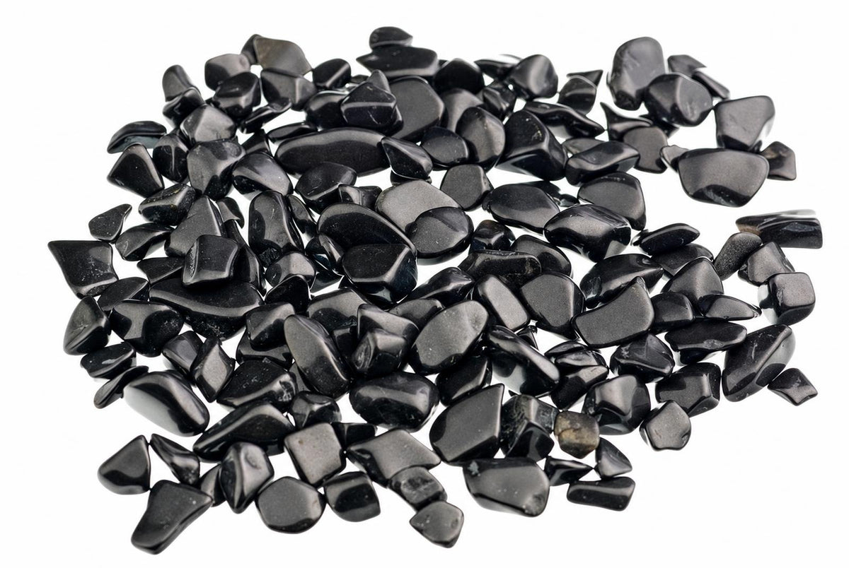A pile of small, smooth black stones on a white background.