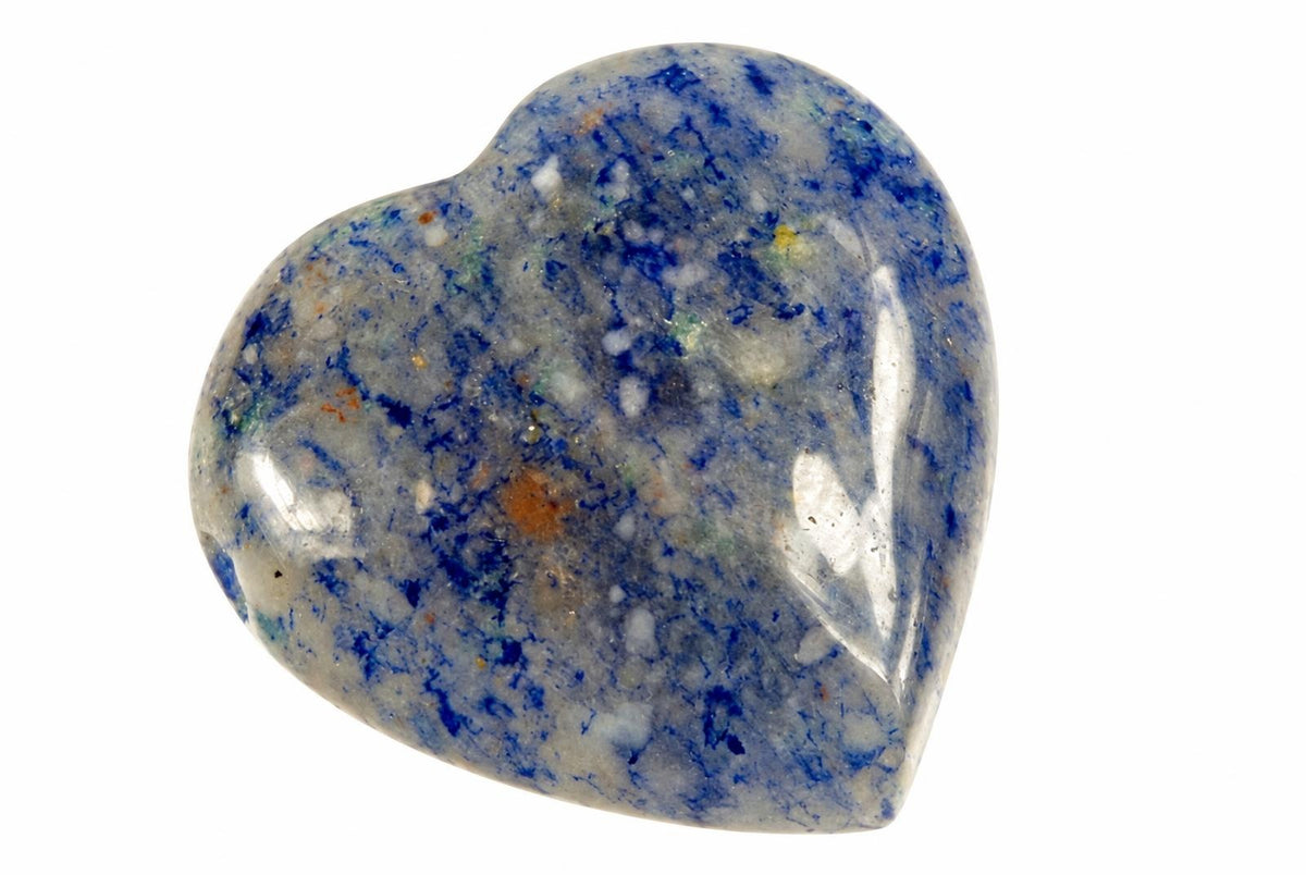 A polished heart-shaped stone with blue, white and orange speckles on a pale background.