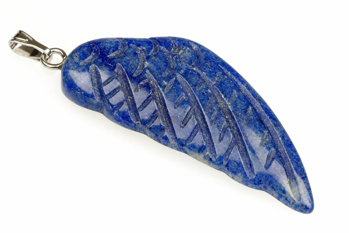 A blue stone pendant shaped like a wing with carved lines, attached to a silver-toned bail on a white surface.