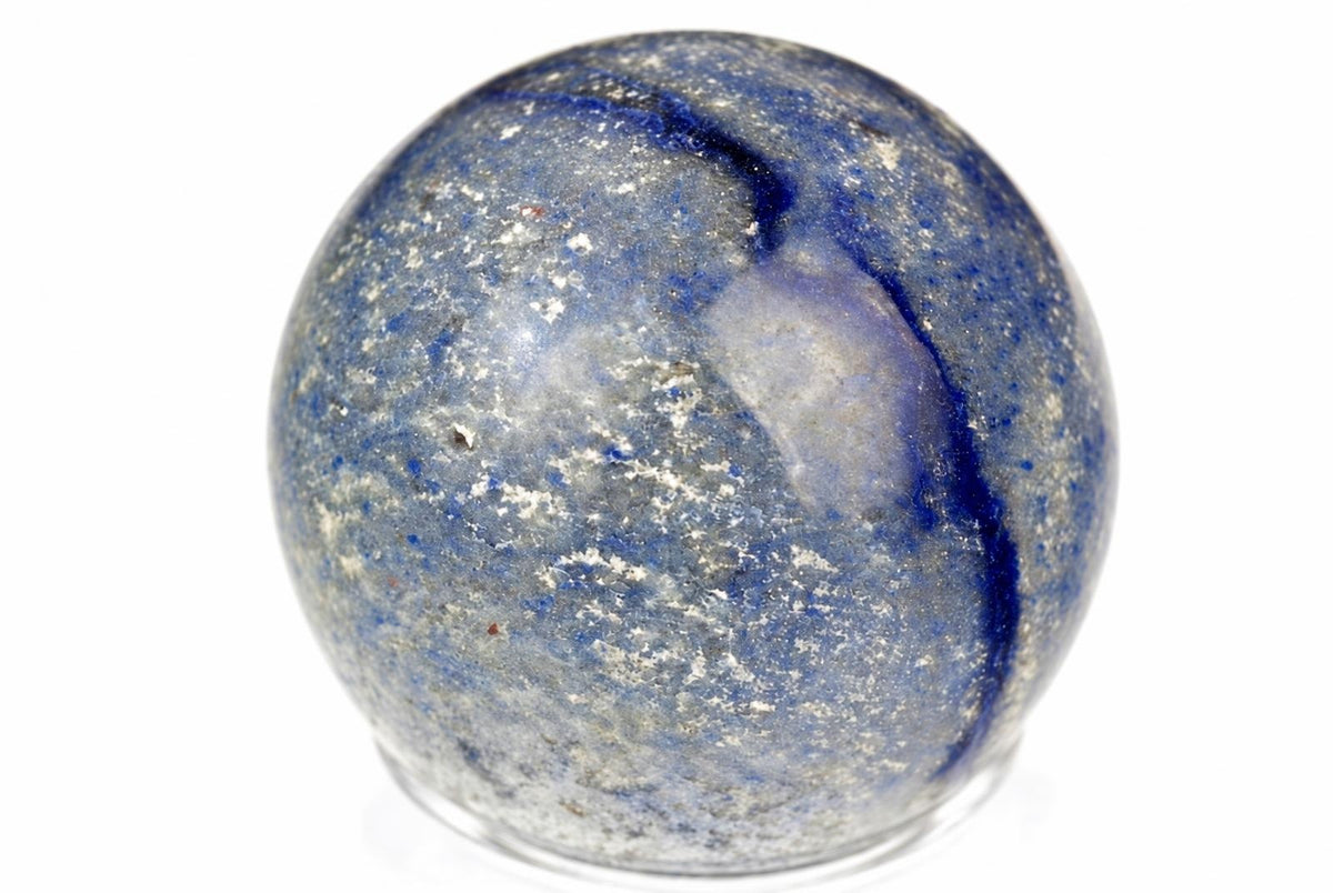 A polished blue and white speckled sphere with a dark blue vein, resting on a clear stand against a white background.