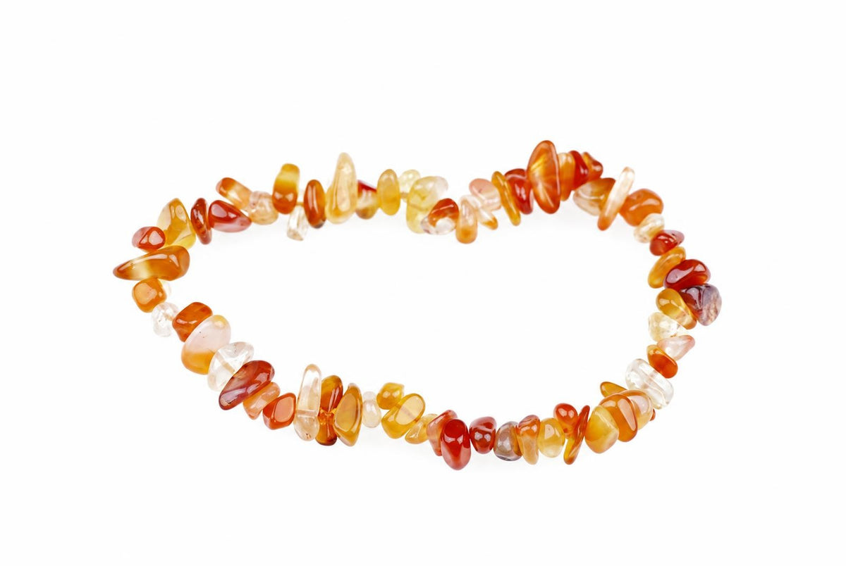 A bracelet made of irregular chips in shades of orange, red, yellow and clear on a white background.