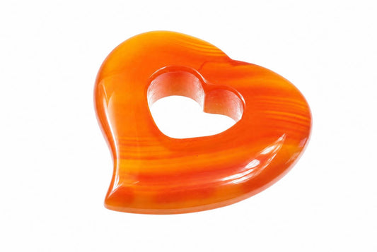 A glossy, heart-shaped pendant with a central heart cutout, featuring orange and yellow swirls on a white background.