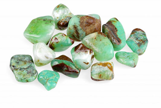 A pile of polished, irregularly shaped stones in green and white with brown patches on a white surface.