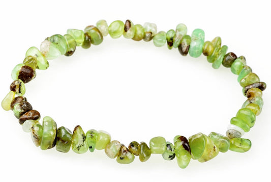 A bracelet made of irregular chips in light green, dark brown and pale tones arranged on a white surface.