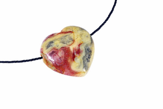 A heart-shaped pendant with swirling red, yellow and grey patterns on a dark cord against a white background.