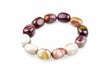Bracelet of polished rounded beads in cream, burgundy, pink and mustard yellow, arranged in an oval on a white background and viewed at an angle.