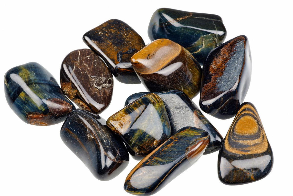 A pile of polished, smooth stones with dark blue and brown banding on a white background.