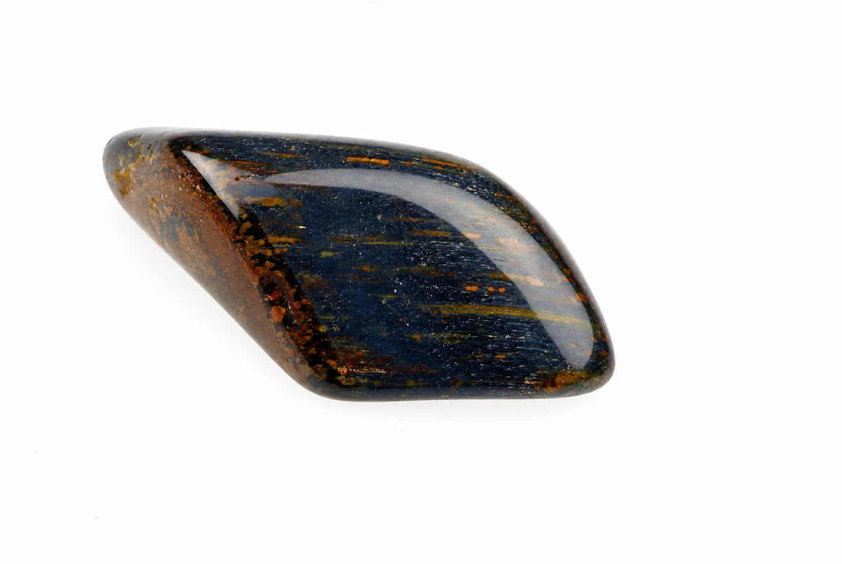 A polished, smooth stone with a dark blue centre and brown edges on a white background.