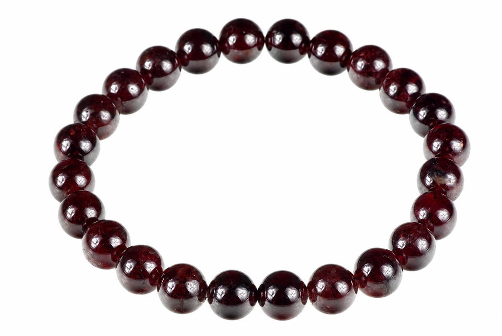A bracelet made of round, polished dark red beads arranged in a circle on a white background.