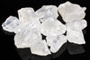 A pile of translucent, white to pale blue crystals with rough shapes on a dark surface.